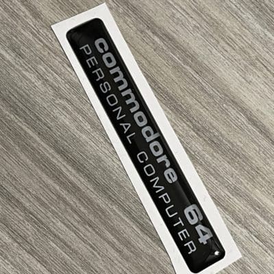 Commodore C64C black / silver badge