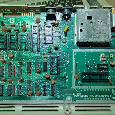 Commodore 64 mainboard with sockets. No warranty. Has bad colour ram chip.